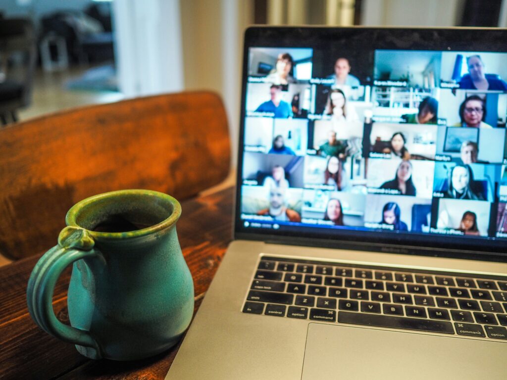 A computer screen and a mug on a table
